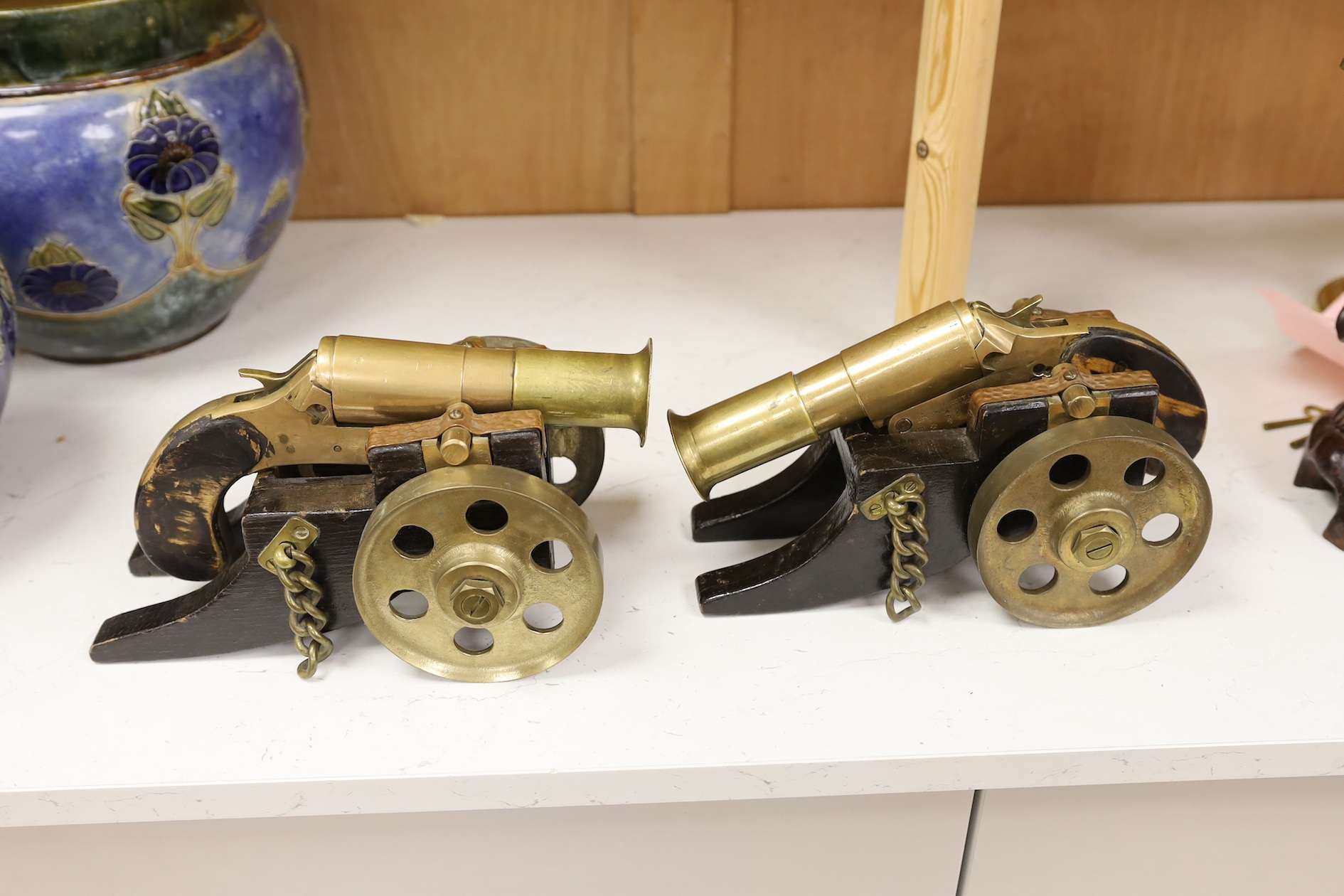 A pair of model bronze and wooden cannons, 27cm long. Condition - worn, strapping rusty